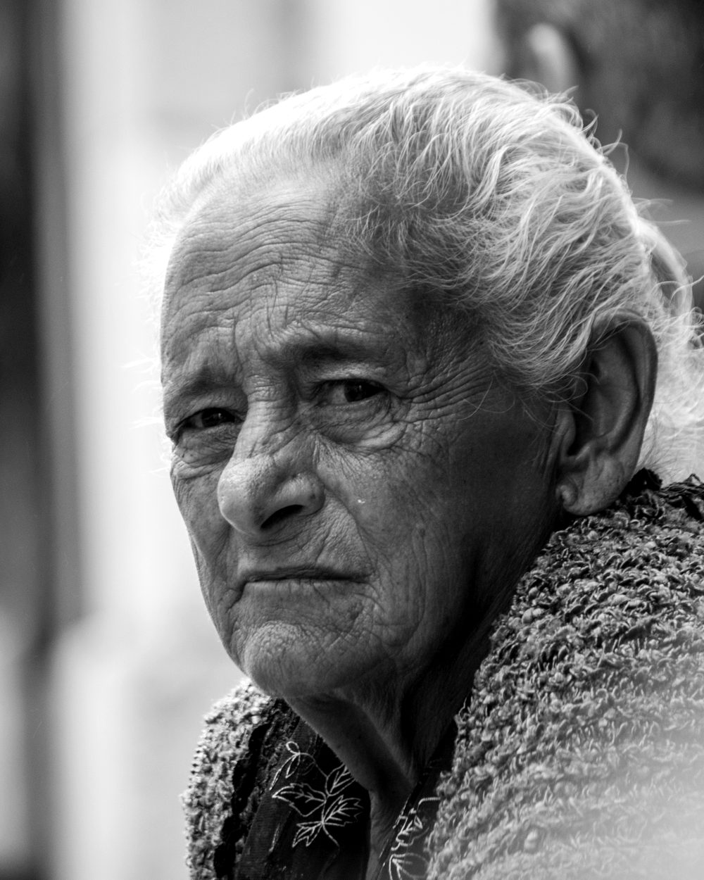 Portrait of an elderly woman looking over her shoulder